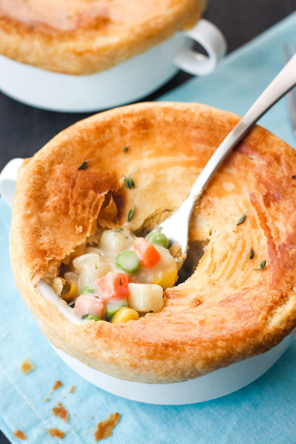 Fork scooping filling out of an individual pot pie.