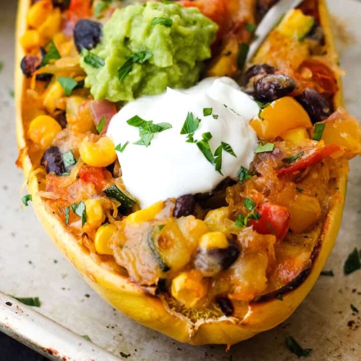 Overstuffed spaghetti squash topped with dollops of guacamole and Greek yogurt.