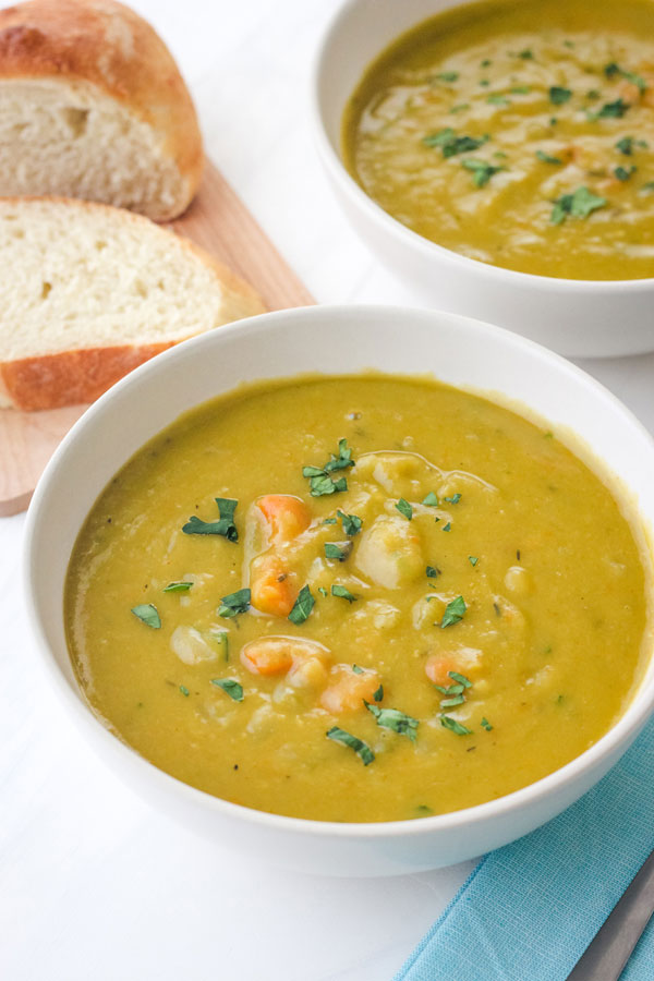 Closeup of pea soup topped with fresh parsley.