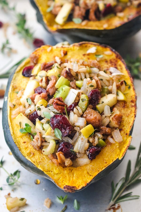 Vegetarian stuffed acorn squash boat on a baking sheet.