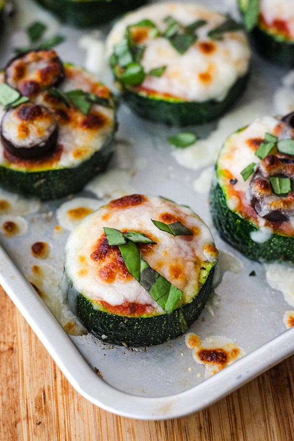 A toaster oven pan full of warm and cheesy zucchini pizza bites.