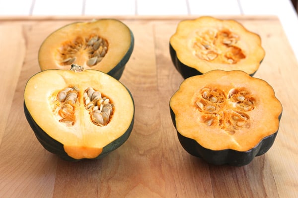 acorn squashed sliced open on a cutting board