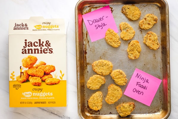 Box of meatless nuggets next to a sheet pan of air fried nuggets.