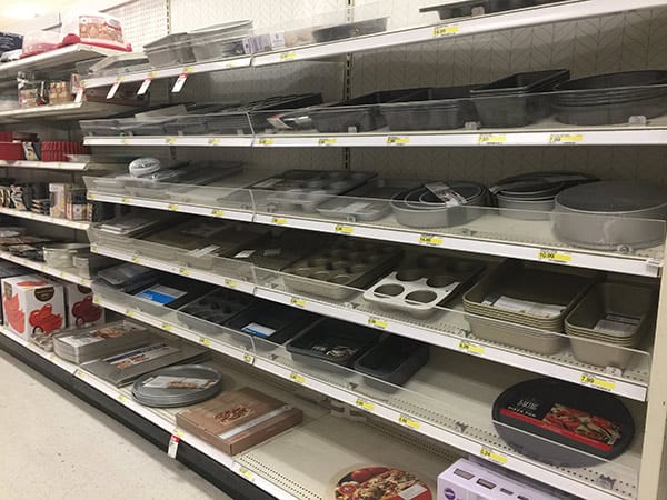 Shelves of baking pans in a department store.