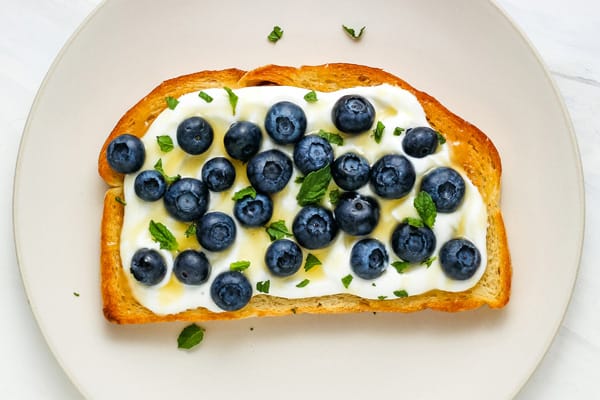 Blueberry dessert toast on a plate.