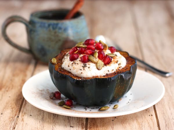 acorn squash bowl filled with yogurt, pomegranate and chia seeds 