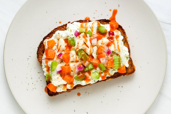 Ranch toast with veggies and a drizzle of buffalo sauce.