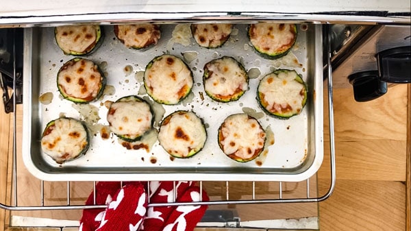 Person pulling a pan of veggie bites out of a toaster oven.