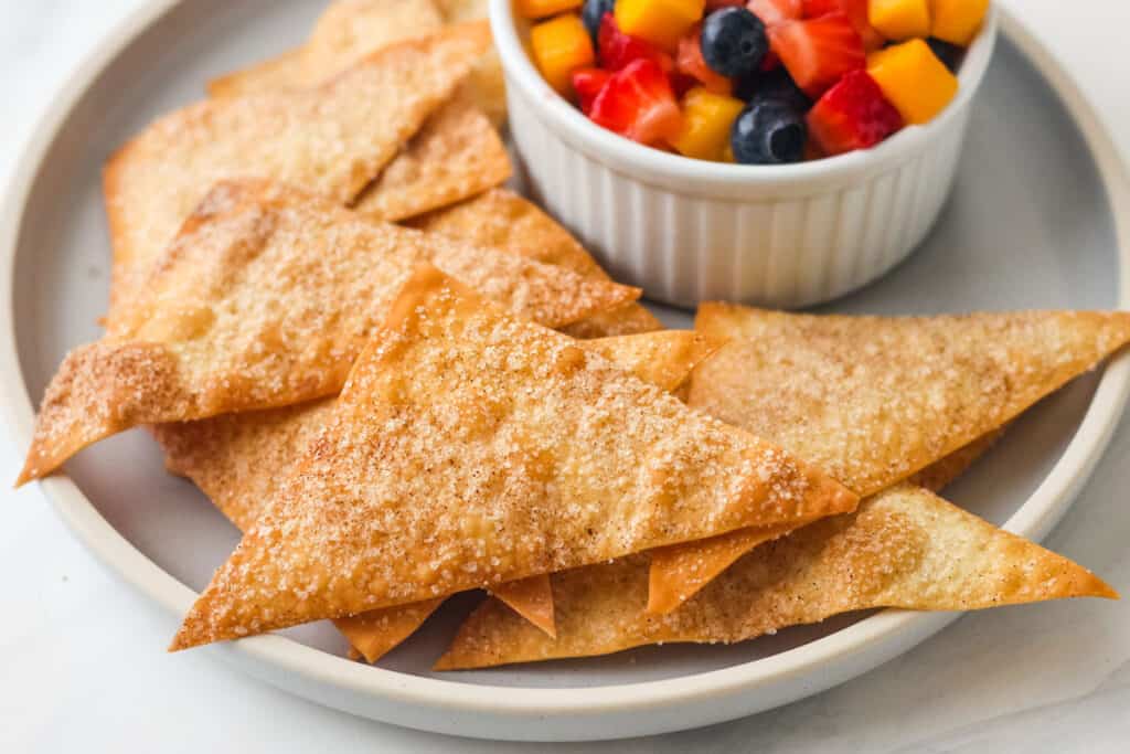 Closeup of golden brown wonton chips sparkling with cinnamon sugar.