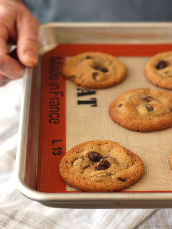 Baked cookies on a pan lined with a silicone baking mat.