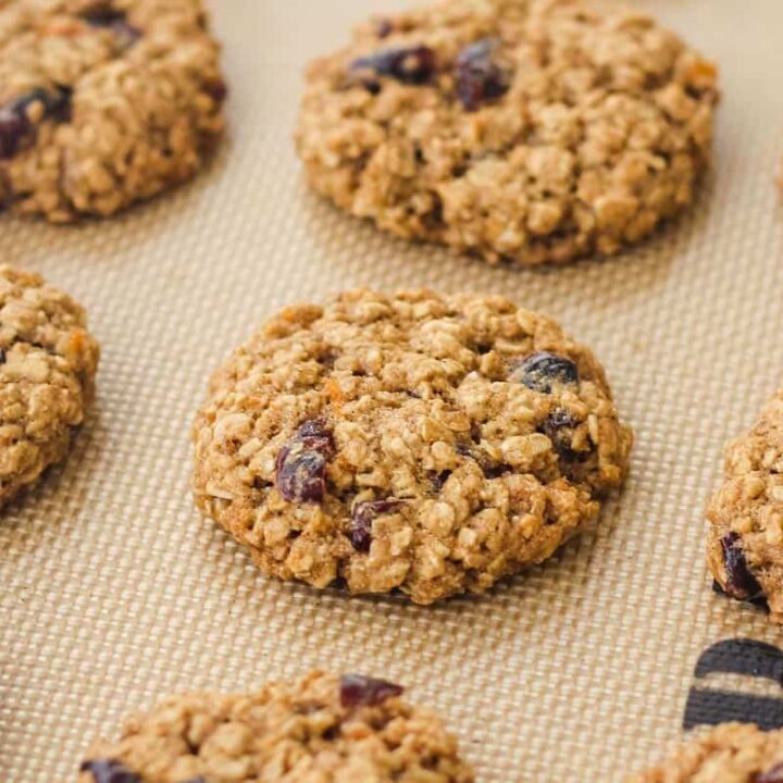 Closeup of baked cookies on a lined sheet pan.