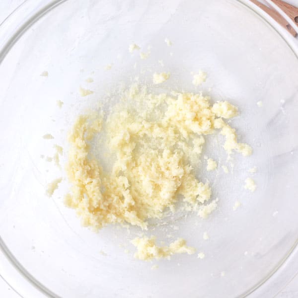 Light and fluffy creamed butter in a glass mixing bowl.