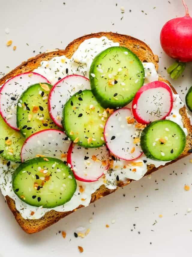 Toasted bread topped with cottages cheese, sliced cucumber, and radishes.