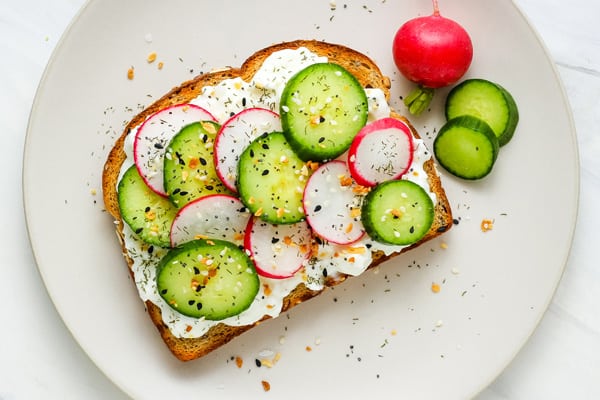 Toast with radish and cucumber slices.