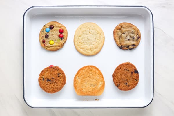 Baked cookies on a small white rimmed pan.