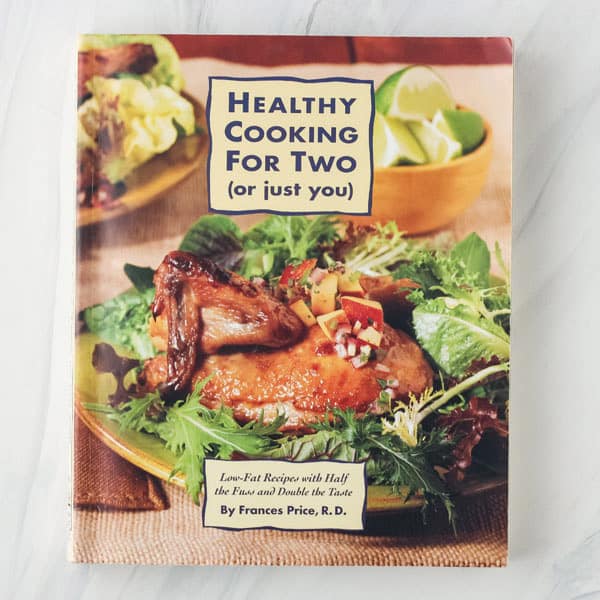 Healthy Cooking For Two cookbook cover with cooked hen on a plate of greens.