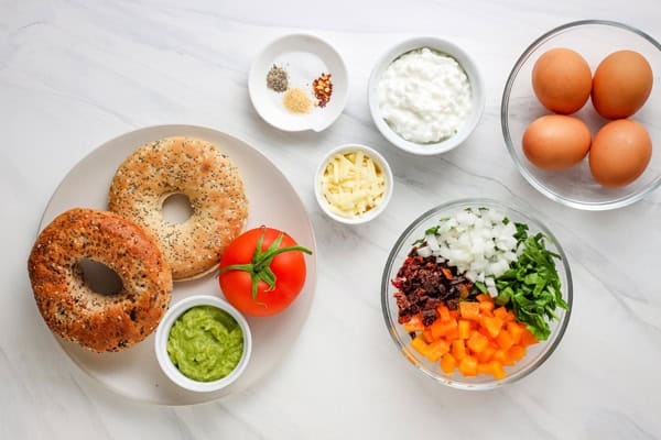 Recipe ingredients arranged in bowls and plates on a table.