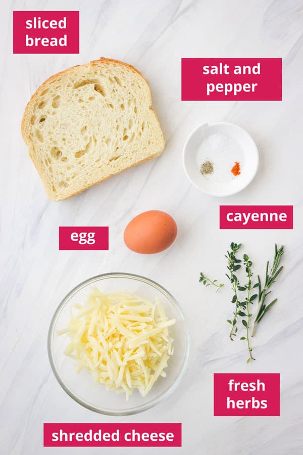 Ingredients to make egg and cheese toast with fresh herbs.