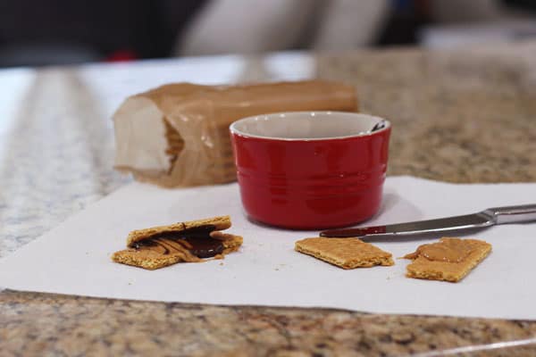 Melted chocolate on a graham cracker with peanut butter.