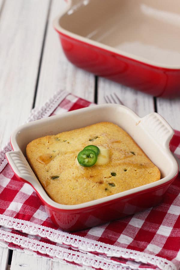 Mini jalapeno cornbread in a red 5 x 5 baking dish.