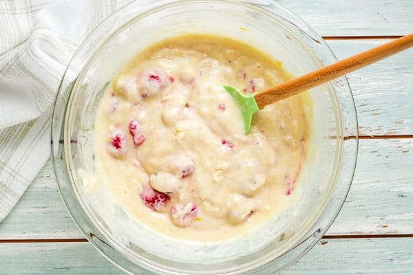 Lumpy muffin batter in a glass bowl.