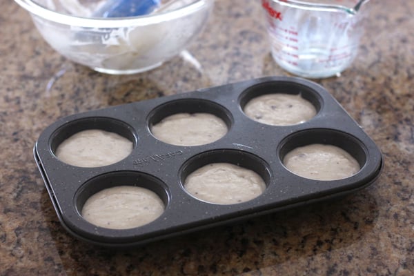 Muffin batter in a muffin pan