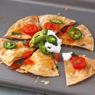 Nachos with Greek yogurt and jalapeno slices.