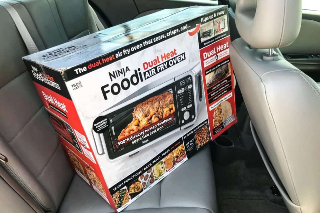 Boxed toaster oven in the backseat of a car.