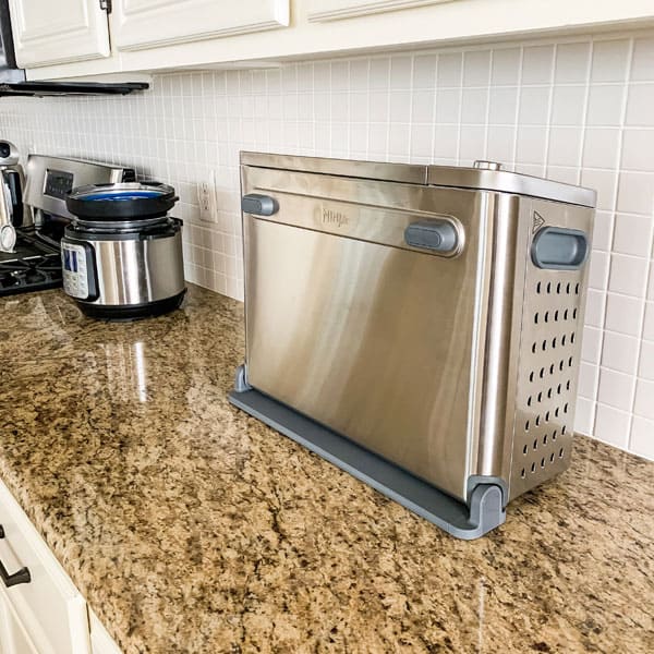 Ninja toaster oven flipped up on a counter.