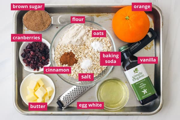 Overhead view of recipe ingredients arranged on a sheet pan with labels.