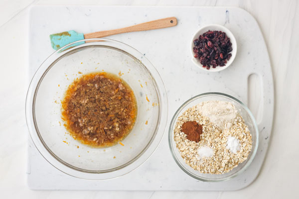 Glass mixing bowls with oatmeal cookie ingredients.