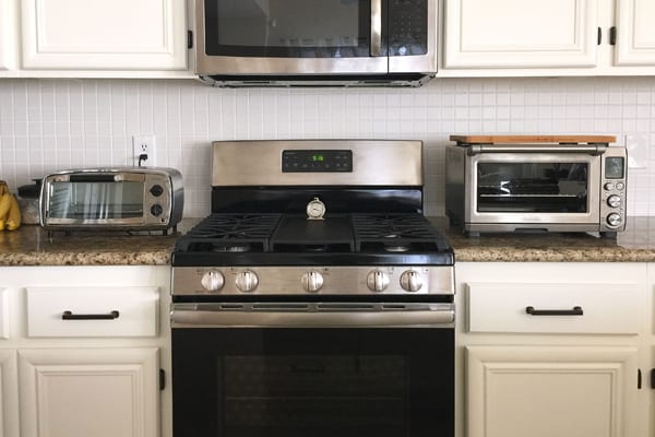 A small Oster toaster oven, large traditional oven and Breville Smart Oven Pro.