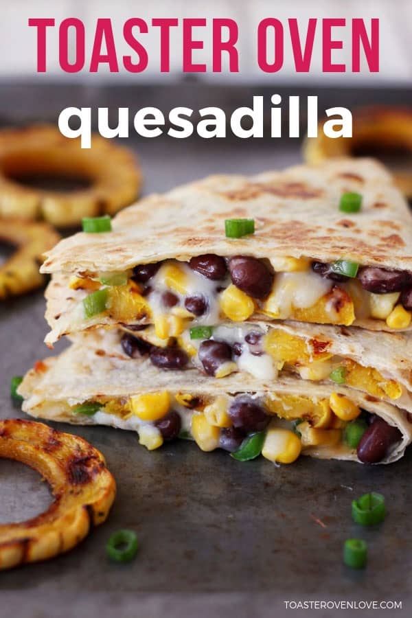 Quesadilla wedges stacked on a baking sheet oozing melted cheese.