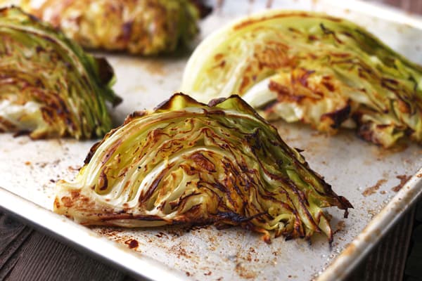 Golden roasted cabbage on a baking sheet.