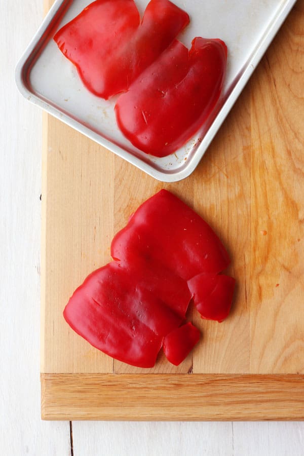 Red pepper halves on a toaster oven baking pan.