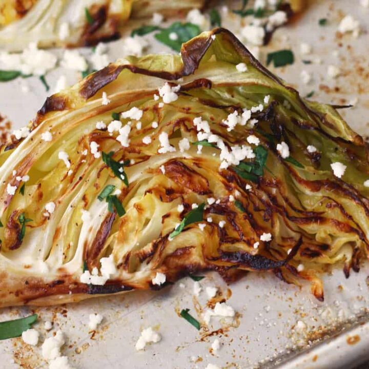 Close up of roasted cabbage on a sheet pan.