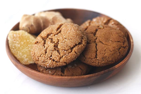 Cookies in a wooden bowl with fresh and candied ginger.