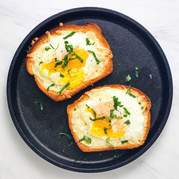 Round cast iron griddle with egg toasts.