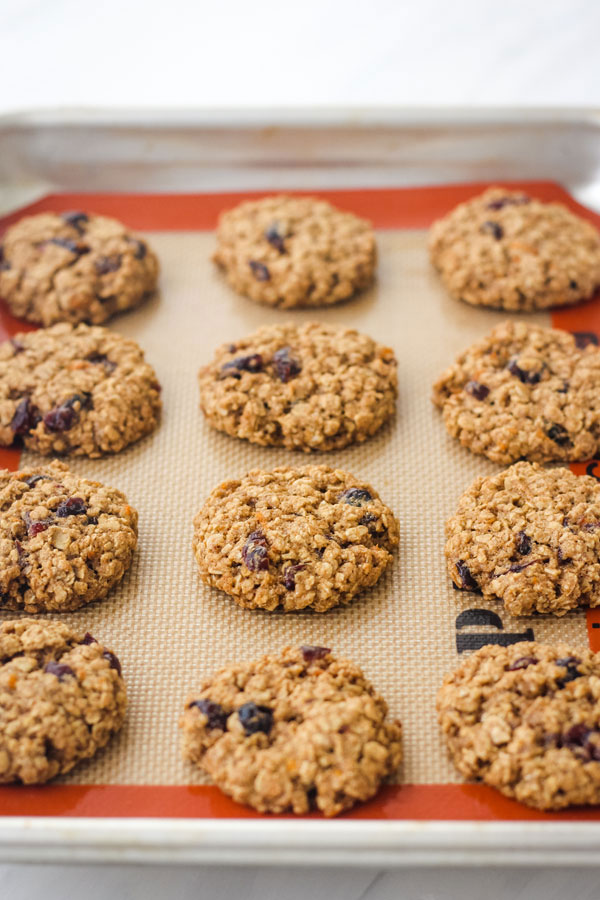 Baked oatmeal cookies on a quarter sheet pan.