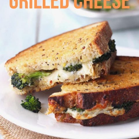 Toaster oven grilled cheese sandwich stuffed with roasted broccoli on a plate.