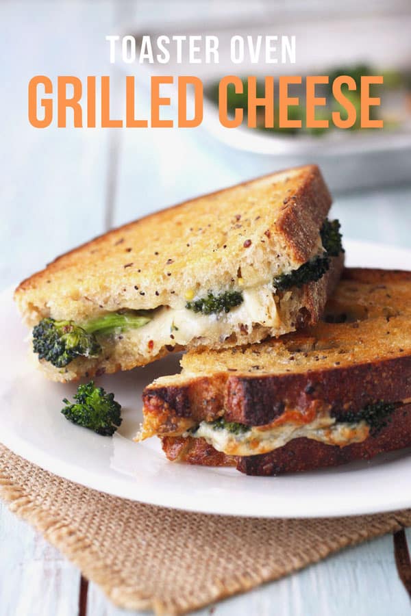 Toaster oven grilled cheese sandwich stuffed with roasted broccoli on a plate.