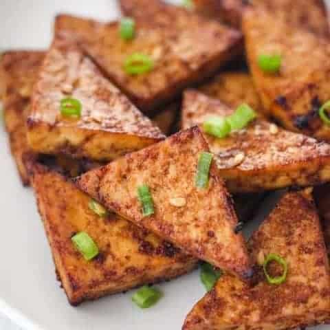 Tofu wedges on a white plate.