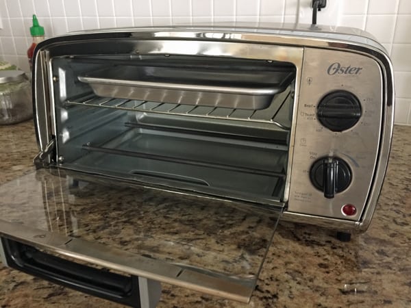 Little toaster oven with rack in top placement and set to broil.