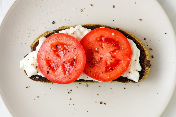 Tomato slices with salt and pepper on toast.