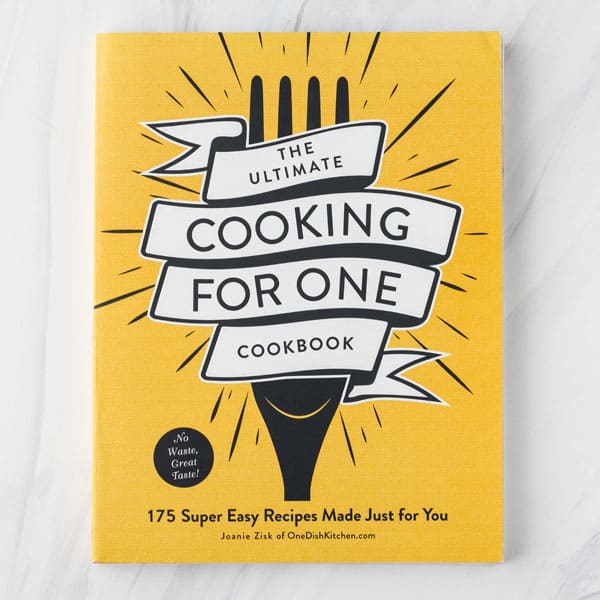 Ultimate Cooking For One Cookbook cover with a fork graphic on yellow background.